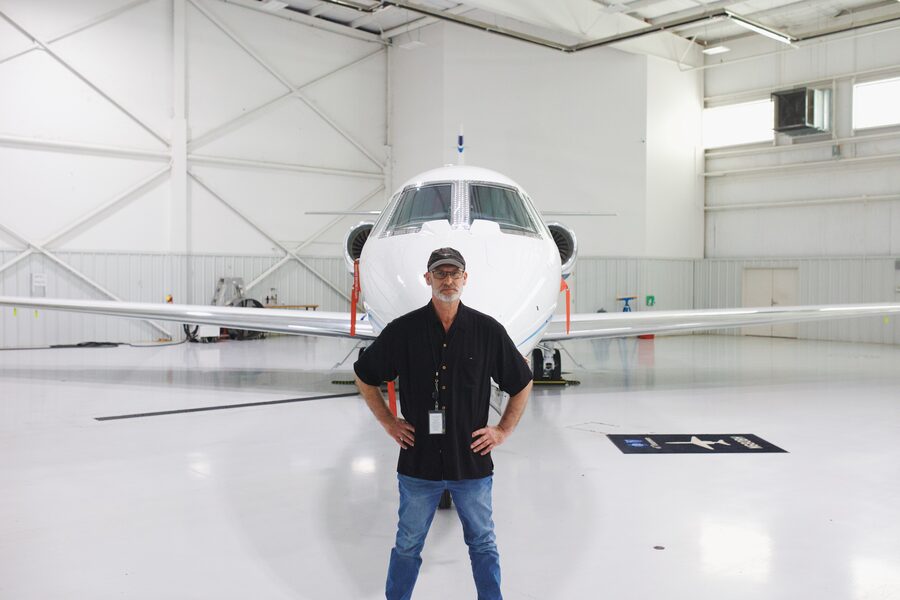 Daniel D. Barks standing in front of a private jet