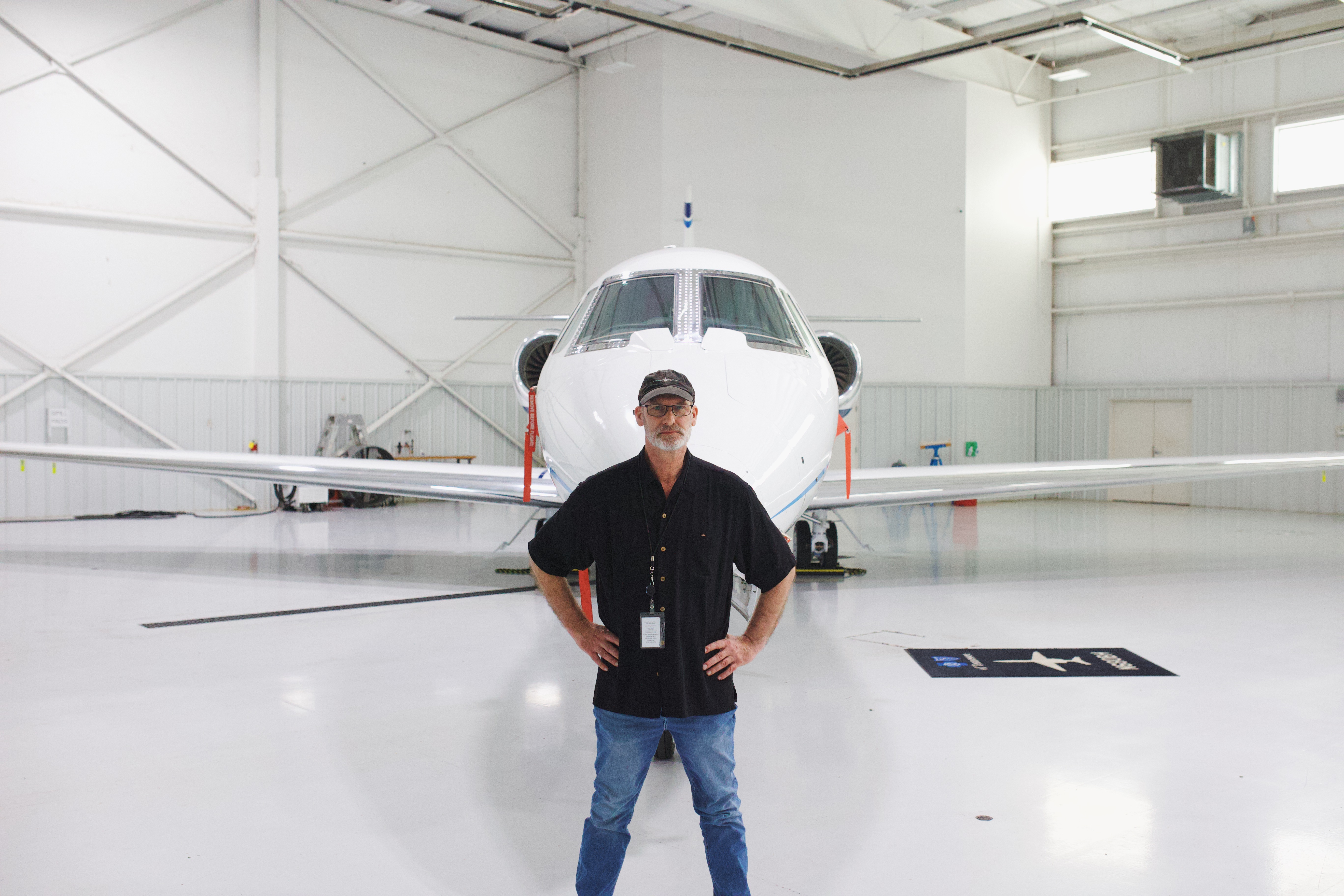 Daniel D. Barks standing in front of a private jet (full resolution)
